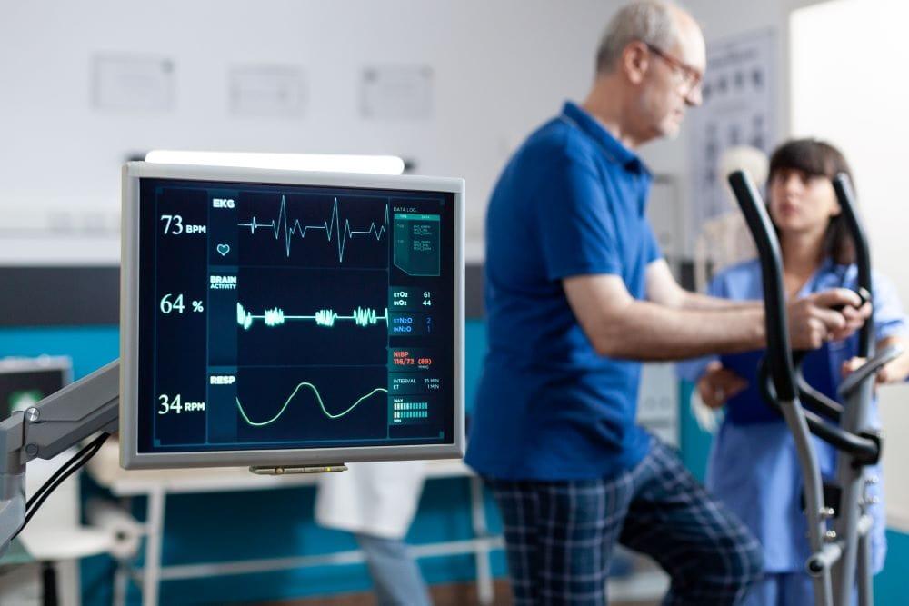 Physiotherapist performing chest physiotherapy and breathing exercises with patient at home