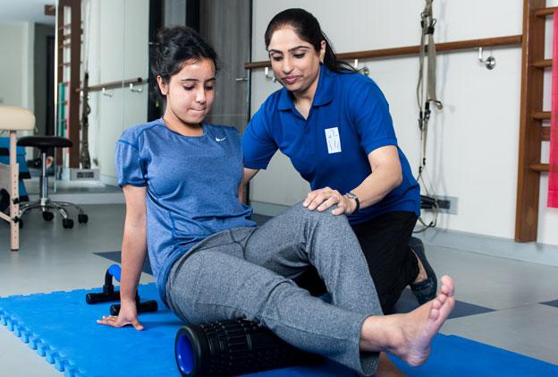 Women's health physiotherapist providing postpartum rehabilitation and pelvic floor therapy at home